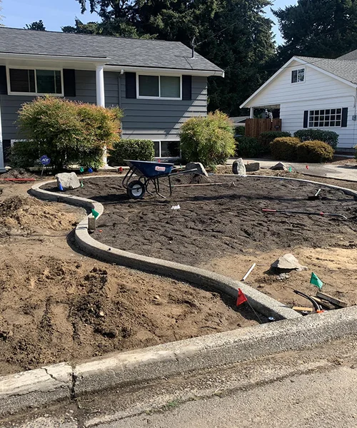 Irrigation systems, concrete curbs, plant design, and landscape rocks with grass seed in Fircrest 